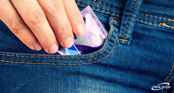 a person putting a condom in their pocket