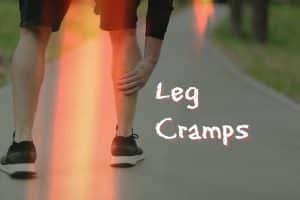 A person feeling their calf muscle as they are having a leg cramp