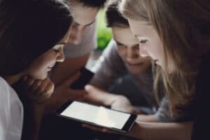 Group of teenagers looking at an ipad