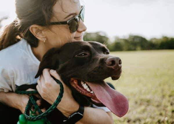 a women hugging her dog