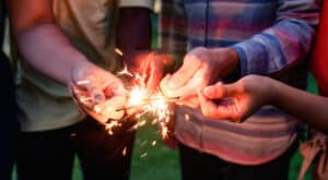 A group of friends holding sparklers
